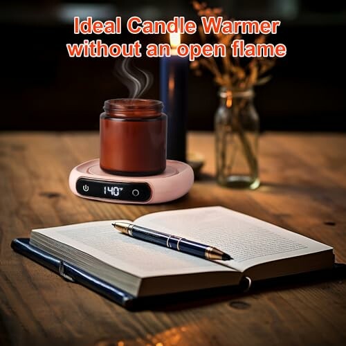 Candle warmer next to an open book and pen on a wooden table.