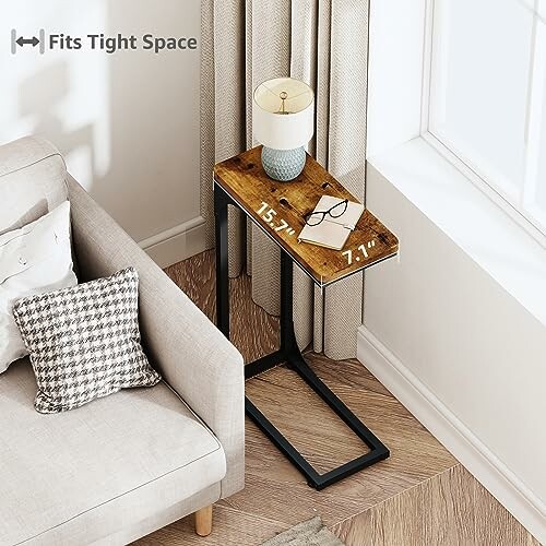 Compact side table next to a sofa in a small living space.