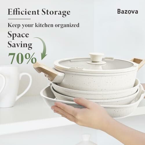 Hand arranging stackable kitchen pots and pans for space-saving storage