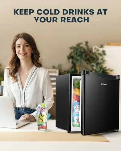 Woman working at desk with mini fridge open, showing drinks inside